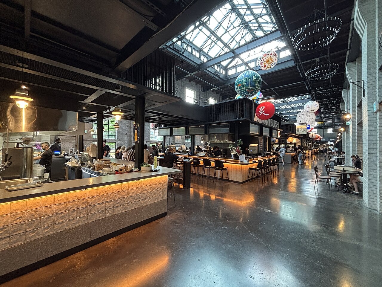 Dining tables and food counters inside Waterworks Food Hall
